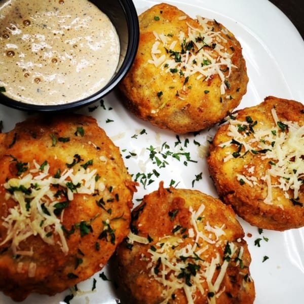 Golden fried stuffed mushrooms topped with parmesan and parsley, served with a creamy dipping sauce.
